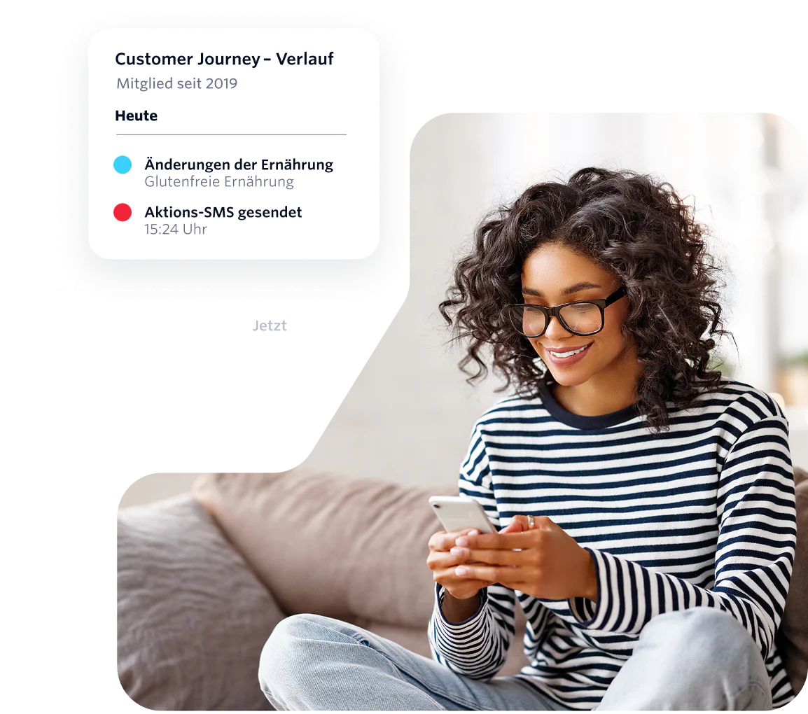Woman with curly hair and glasses using a phone while receiving messages on a customer journey timeline.