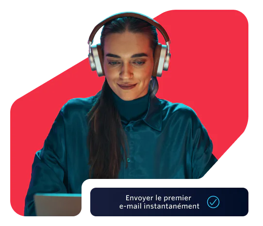 Woman in headphones using a laptop with a prompt to send the first email instantly