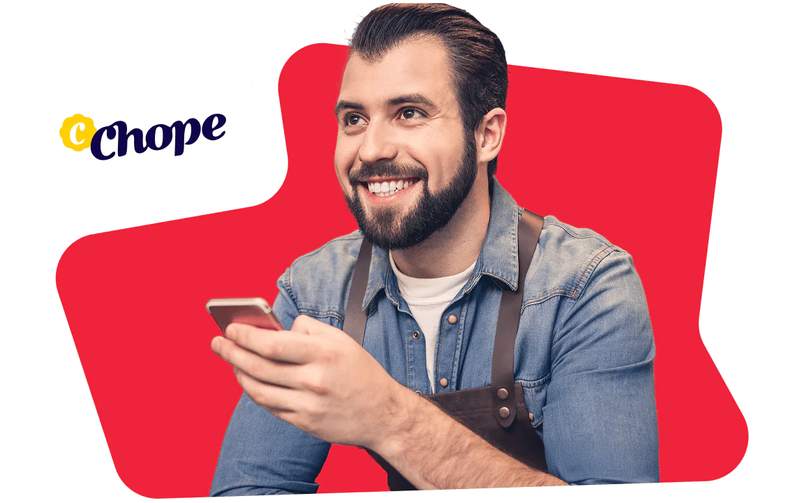 Bearded man in a denim shirt, holding a phone, Chope logo in the top left, red background
