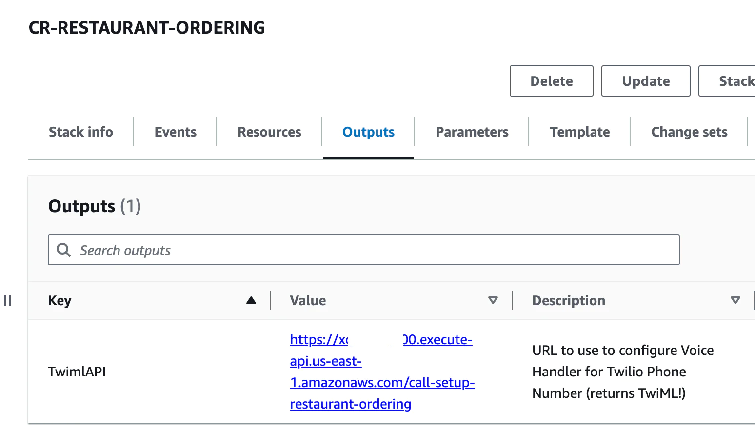 Screenshot of AWS CloudFormation stack outputs page showing Twilio API URL and related details.