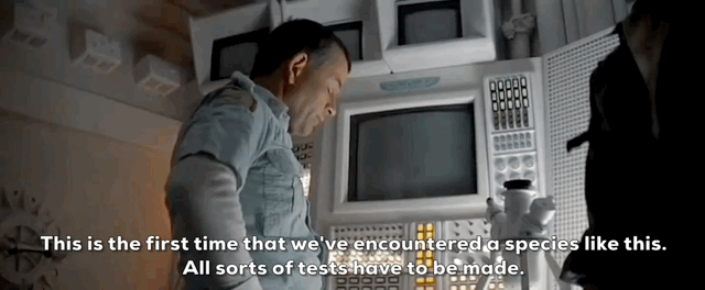 Scientist examines equipment in a lab with a caption about encountering a new species.