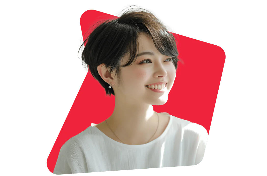 Smiling woman with short dark hair wearing a white top and earrings, set against a red background.