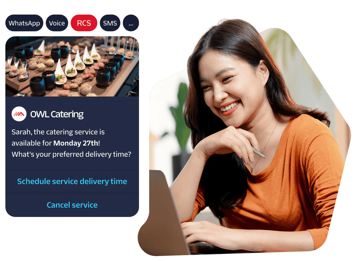 Woman smiles at her laptop while reading a catering service notification.
