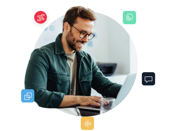 Smiling man using a laptop, surrounded by communication icons including chat, WhatsApp, and voice.