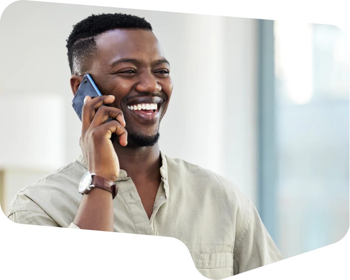 Man smiling and making a phone call with a smartphone
