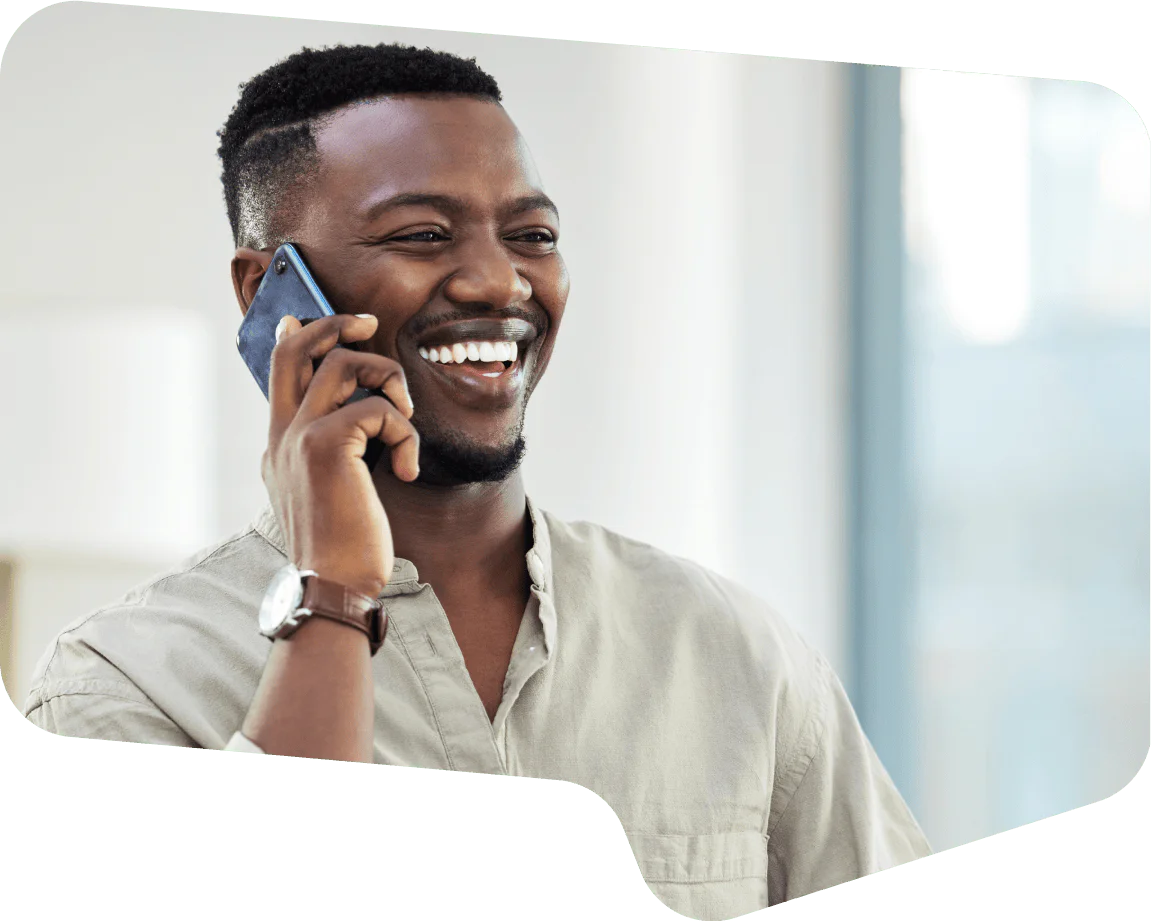 Man with short hair talking on the phone and smiling